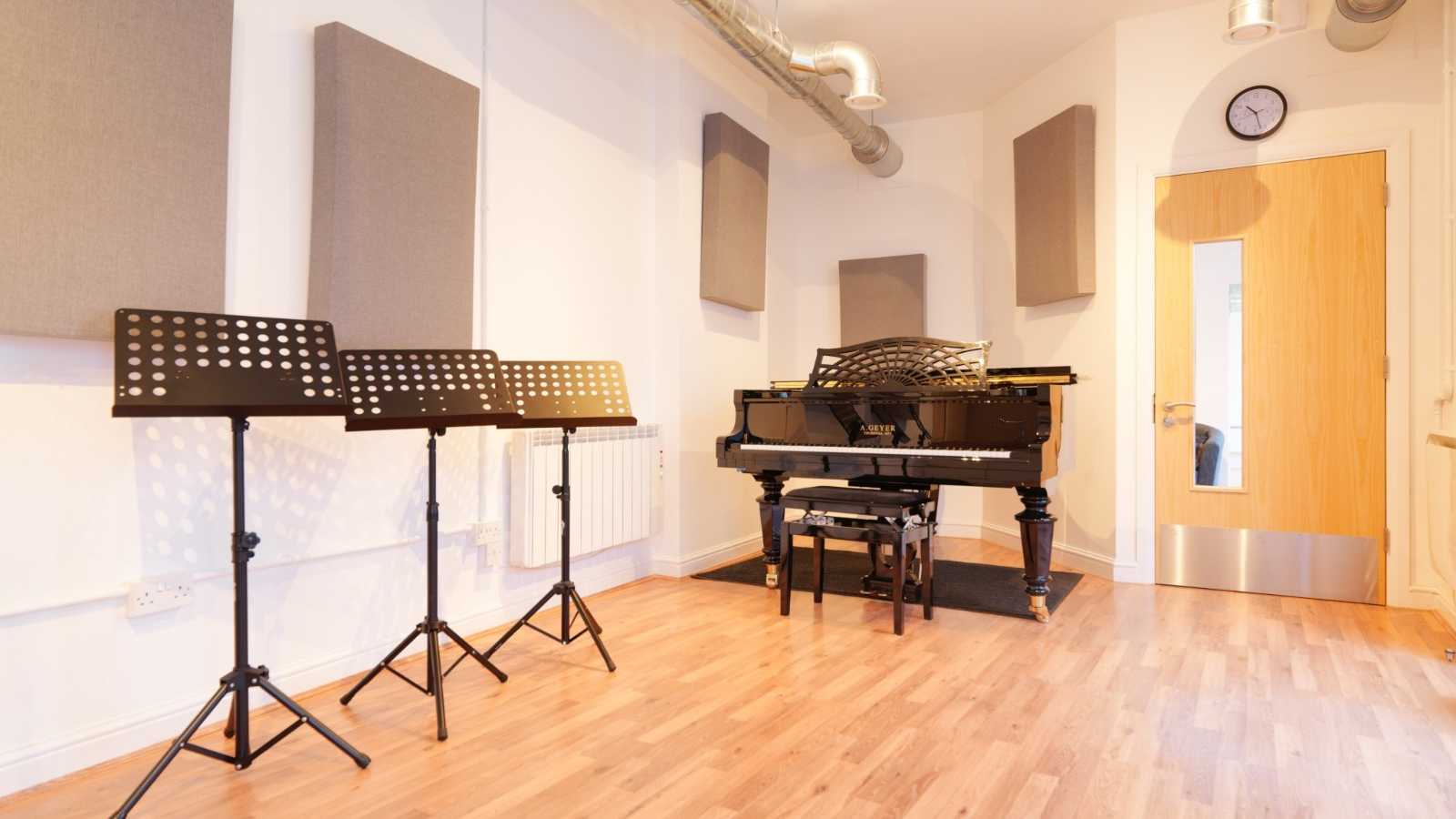 piano in a room with vaulted ceiling