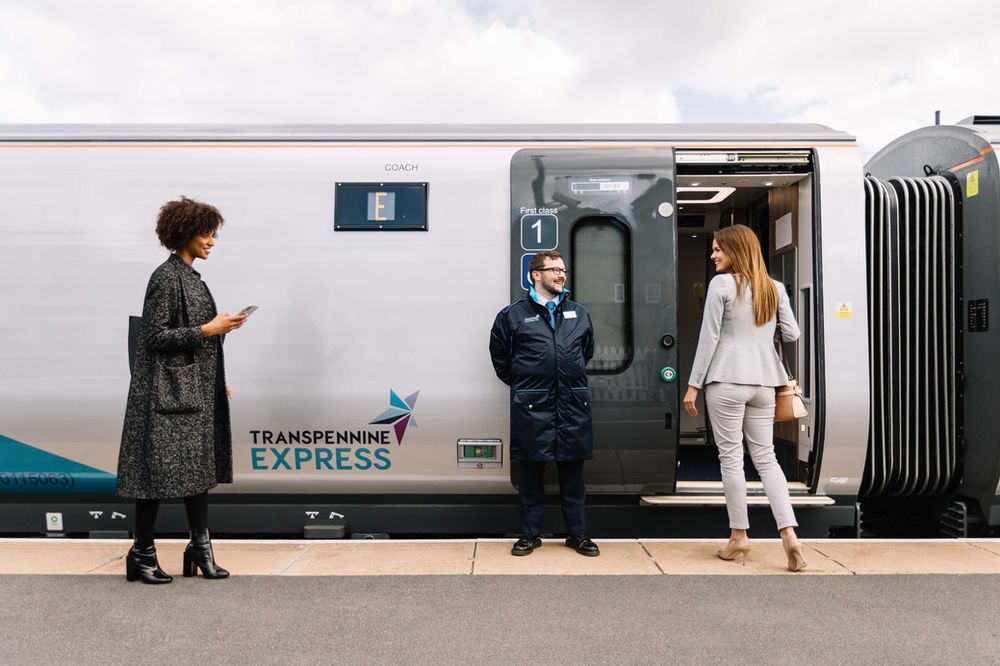 image showing a train conductor and two passengers about to board a train by Stuart Bailey