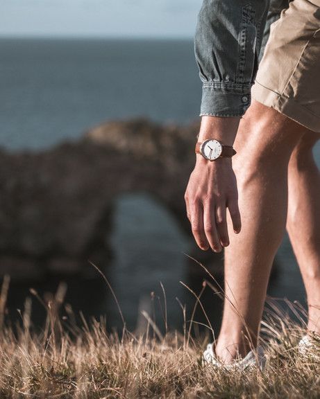 image showing a mans hand with a watch on, leaning down with a cove in the background by Pete Elliott