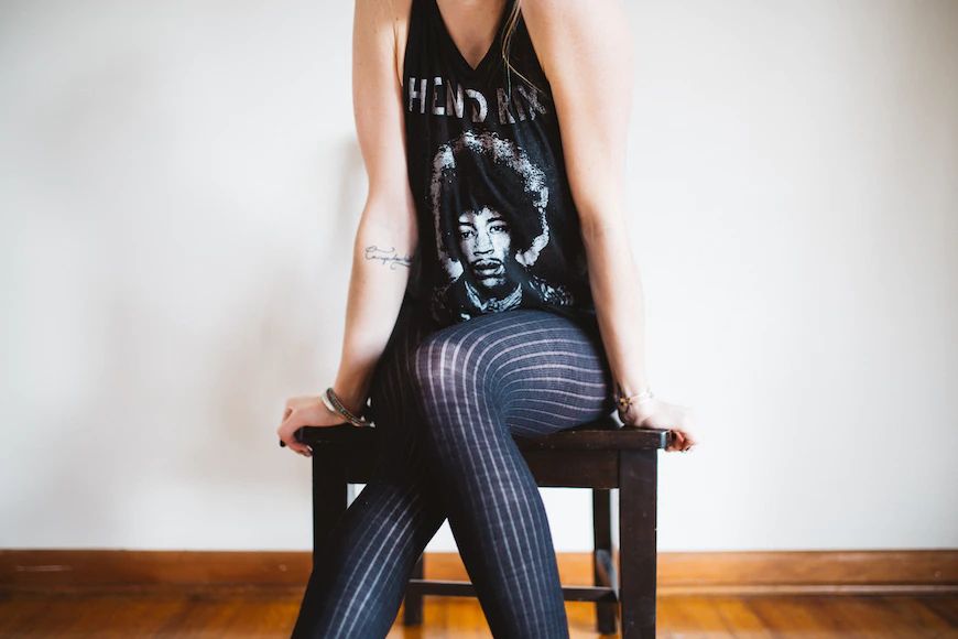 image of a woman sat on a stool in a Jimi Hendrix band tee