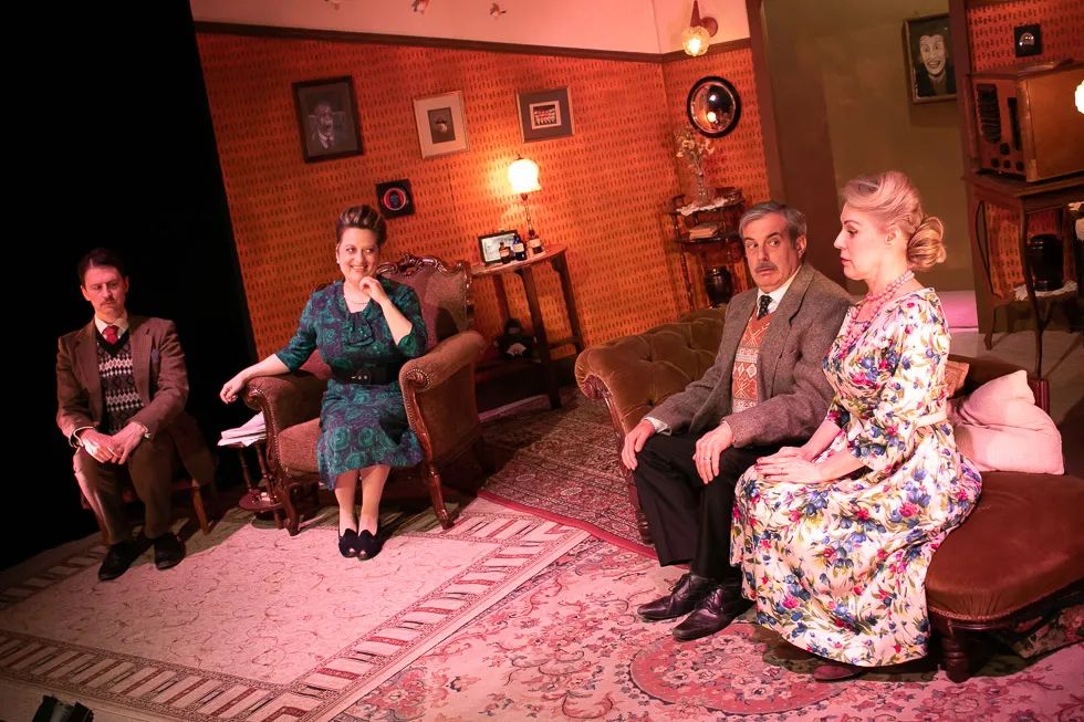 Image by South London Theatre of actors sitting on chairs on a stage in vintage costumes