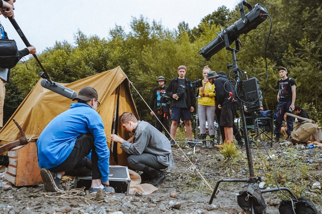 image showing a film crew gathered around a tent 