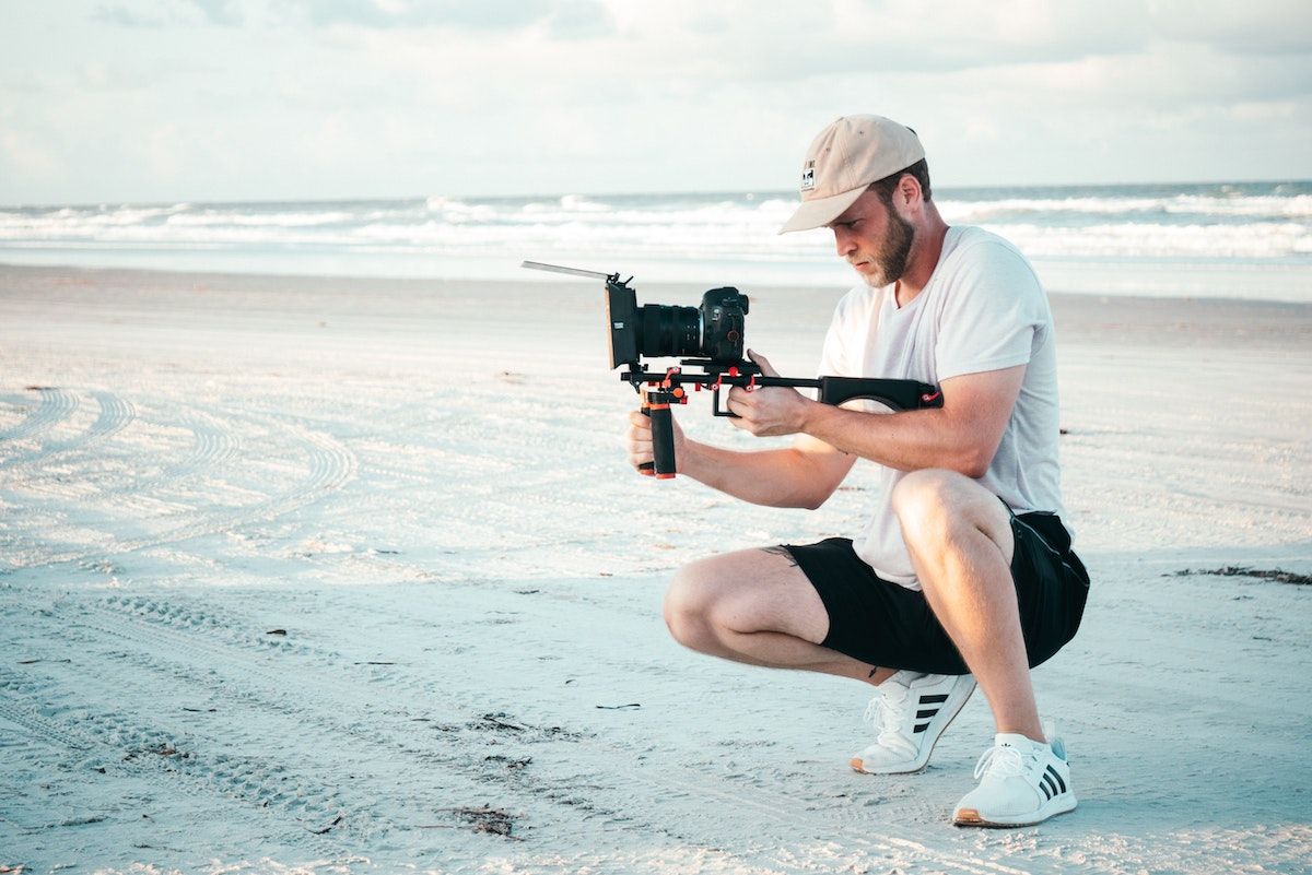 image of a man filming at beach