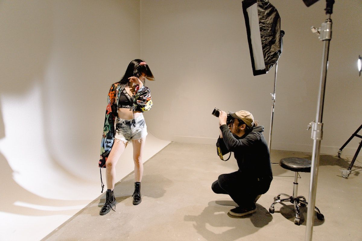 fashion photographer taking photos in a photography studio